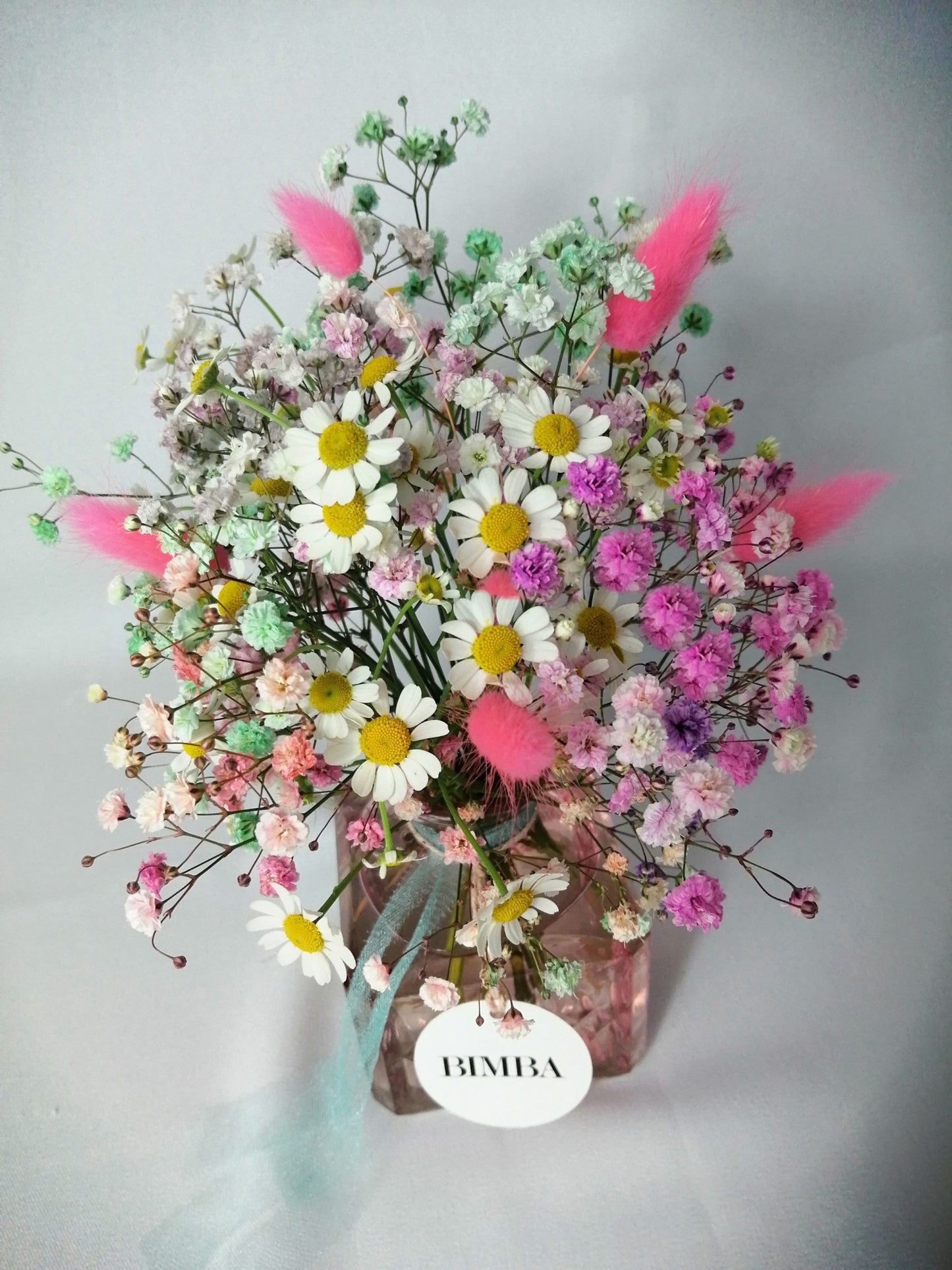 Happiness in a bouquet!! :) Perfect to add a pop of colour like a little rainbow to any place. Mini floral arrangement featuring rainbow gypsophila, chamomile flower and floppy bunny tails in a lovely vintage style glass vase, ready to enjoy. By Bimba Floral Studio.