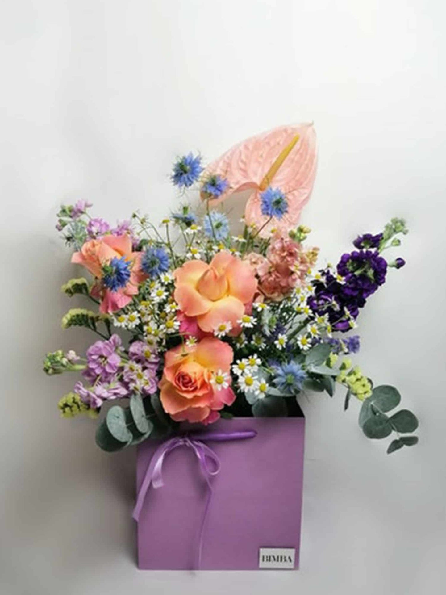 Copenhagen bouquet. It feels like you picked the flower in a lovely meadow. Exquisite bright flower arrangement featuring Lovely roses, elegant Clematis, perfume plant night-scented delphinium, campanula, pink Anthurium, aromatic Matricaria (that makes me think in lots of happy faces!) & Australian sweet scented eucalyptus.
