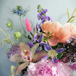 Beautiful flower arrangement, inspired by the breathtaking amalfi coast and the wonderful sunsets.  Featuring a mix of summery flowers in lovely violet, blue and coral tones like caribbean soft pink orchids, sweet scented stock, french clematis, playful bunny tails, scabiosa, Amaranthus, cerise asparagus and our star 'Peony Coral Charm' and 'Peony Angel Cheeks'.
