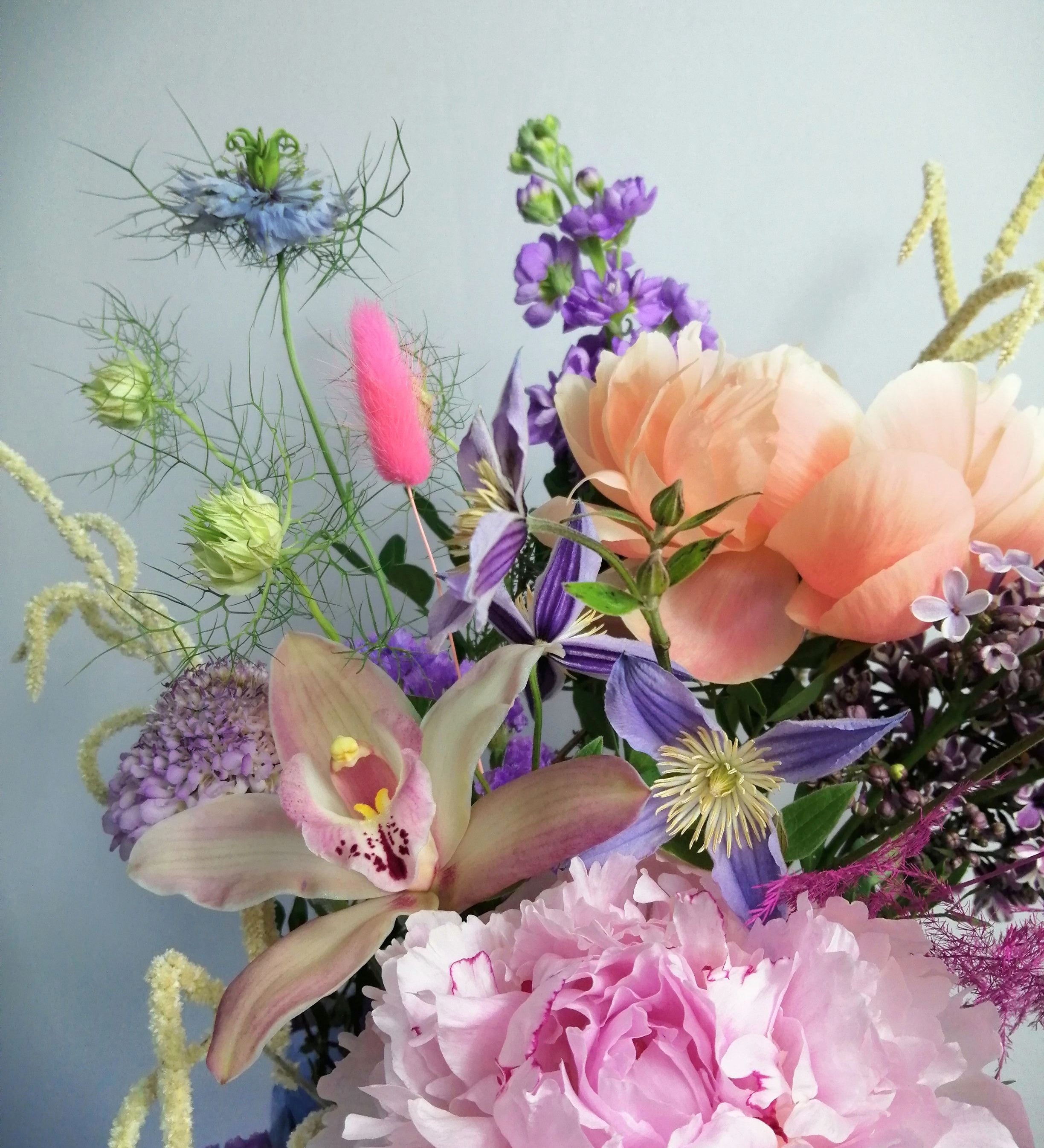 Beautiful flower arrangement, inspired by the breathtaking amalfi coast and the wonderful sunsets.  Featuring a mix of summery flowers in lovely violet, blue and coral tones like caribbean soft pink orchids, sweet scented stock, french clematis, playful bunny tails, scabiosa, Amaranthus, cerise asparagus and our star 'Peony Coral Charm' and 'Peony Angel Cheeks'.
