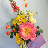 Lovely and happy! Summery flower arrangement in orange, coral and cream tones, featuring, double lisi, Amaranthus, orange roses, dancer Caribbean orchids, snapdragon, bunny tails and our star of the season Peony 'coral charm' abundant, nostalgic, large, elegant glossy coral-cream coloured, semi-double flowers with a slight fragrance as they mature. Just beautiful!! This flower bouquet is available for same day delivery and next day delivery at our floral studio at Highgate ( North London Flowers ).