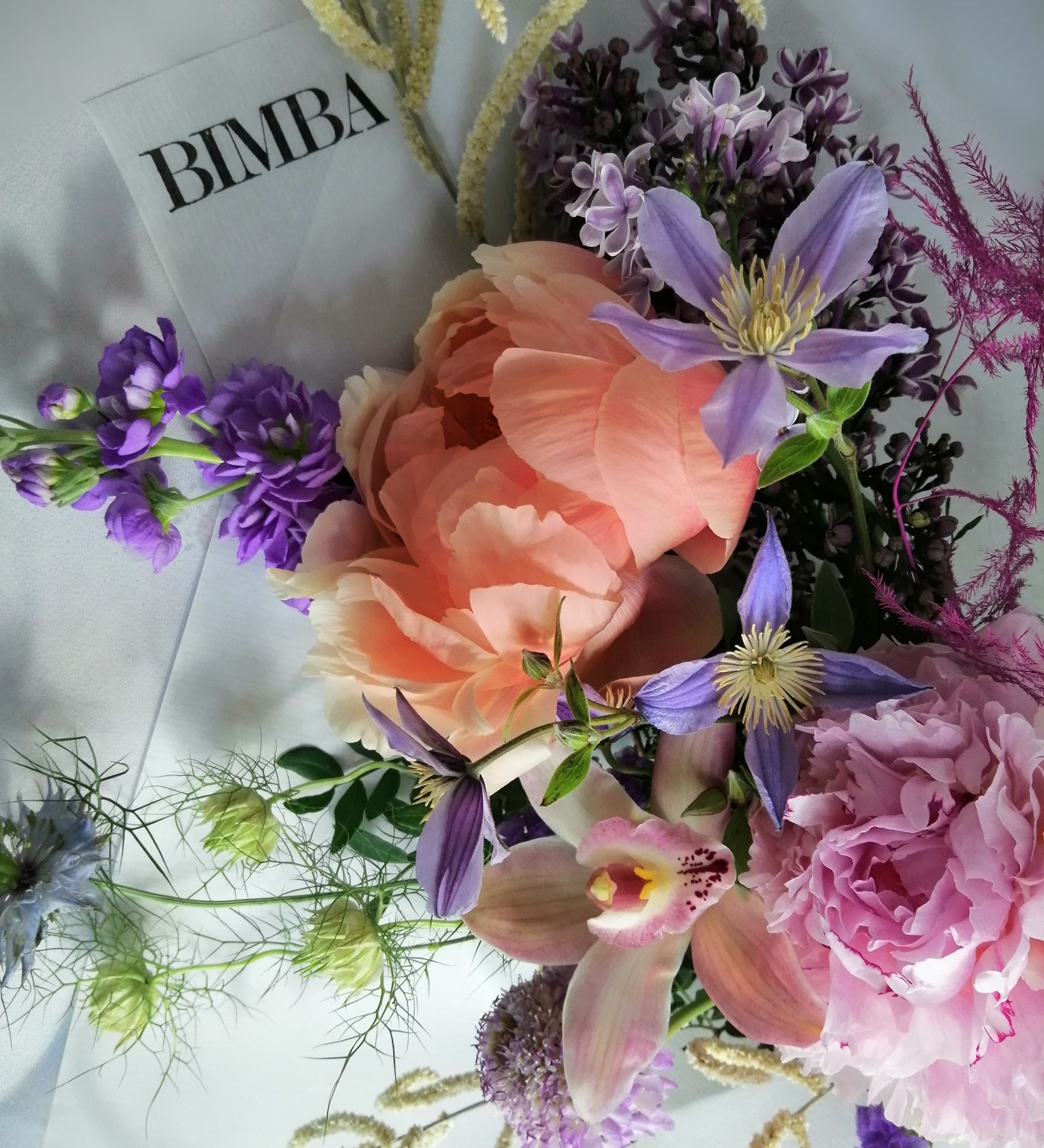 Beautiful flower arrangement, inspired by the breathtaking amalfi coast and the wonderful sunsets.  Featuring a mix of summery flowers in lovely violet, blue and coral tones like caribbean soft pink orchids, sweet scented stock, french clematis, playful bunny tails, scabiosa, Amaranthus, cerise asparagus and our star 'Peony Coral Charm' and 'Peony Angel Cheeks'.