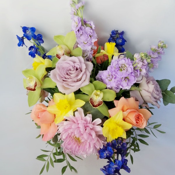 Candy, Lovely and romantic  but at the same time very vibrant and colourful flower bouquet  featuring luxury orchids, lovely roses, sweet scented stock, strawberry chrysanthemums, spring daffodils (only in early spring), blue bell and scented eucalyptus.. By Bimba Floral Studio.