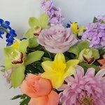 Candy, Lovely and romantic  but at the same time very vibrant and colourful flower bouquet  featuring luxury orchids, lovely roses, sweet scented stock, strawberry chrysanthemums, spring daffodils (only in early spring), blue bell and scented eucalyptus.. By Bimba Floral Studio.