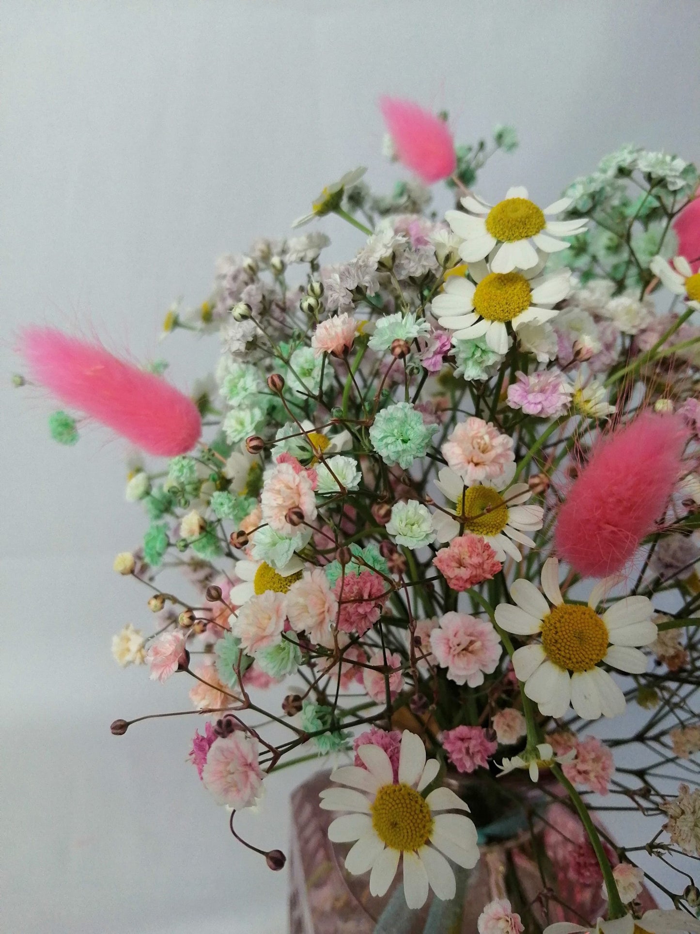 Happiness in a bouquet!! :) Perfect to add a pop of colour like a little rainbow to any place.  Mini floral arrangement featuring rainbow gypsophila, chamomile flower and floppy bunny tails in a lovely vintage style glass vase, ready to enjoy. By Bimba Floral Studio.