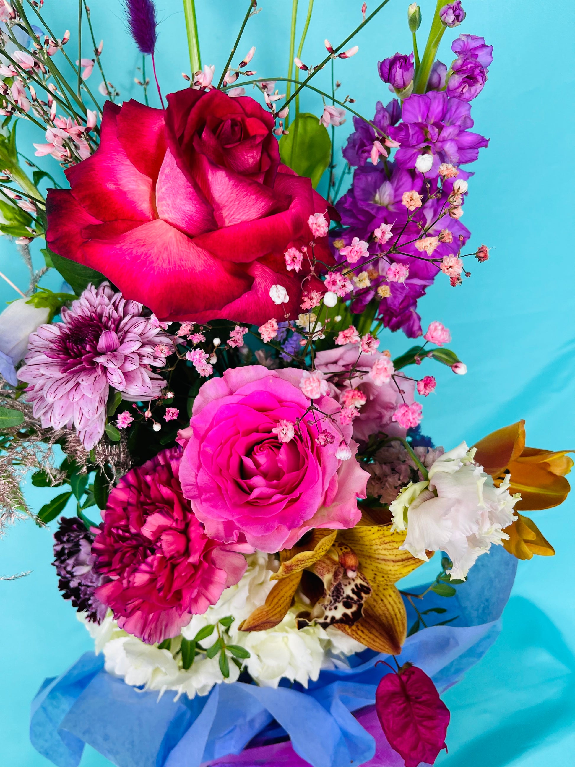 Dancing in the Moon Bouquet is a ovely flower arrangement featuring sweet scented roses, French clematis , double bloom lisianthus, rainbow Gypsophila, luxury cymbidium orchids, sweet scented delphinium, playful bunny tails, champagne asparagus fern and sweet scented eucalyptus. By Bimba Floral Studio.